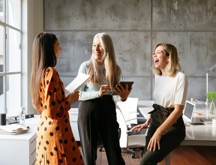 Three female employees at work, having a chat