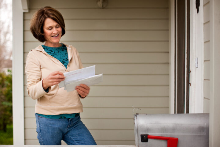 Medicare member opening a health plan marketing piece of mail