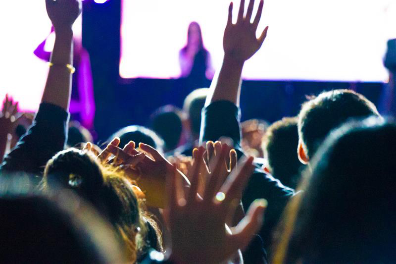 Group of people with their hands up