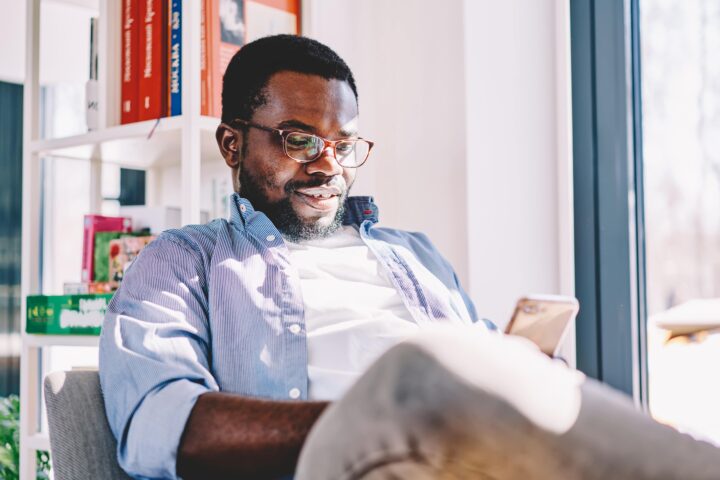 male sitting down looking at cell phone