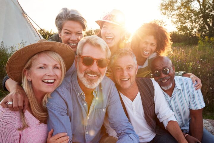 group of middle aged men and women smiling at the camera