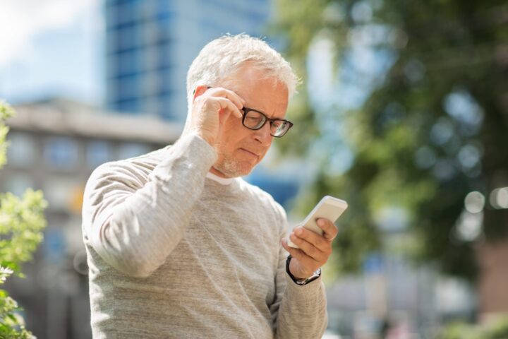 older male looking at cell phone